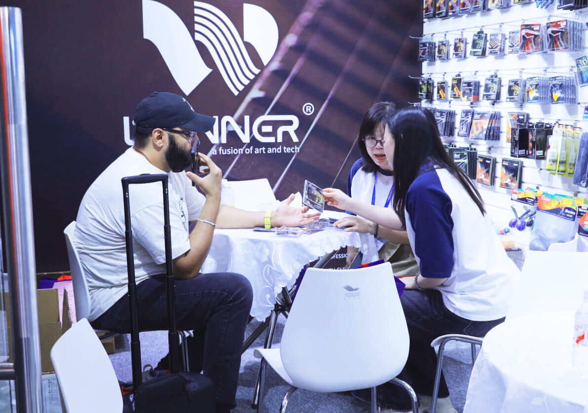 Business discussion at the Winner guitar strings booth Business discussion at the Winner guitar strings booth